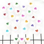 flat round with little heart - colored mix 7 mm